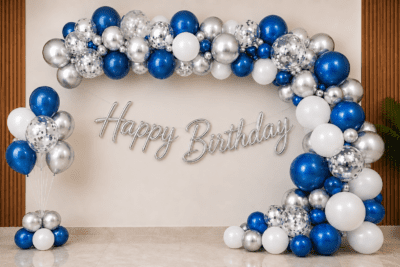 Blue Silver Happy Birthday Balloon Decoration with Cursive Banner Blue, white and silver birthday balloon decoration with metallic balloon arch, silver confetti balloons, floor balloon cluster and silver cursive Happy Birthday banner.