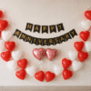 Heart Shape Happy Anniversary Balloon Decoration Romantic Happy Anniversary wall decoration with red and white heart-shaped balloons, black and gold banner, and two pink heart foil balloons.