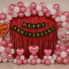 Romantic Happy Anniversary Decoration with Pink & White Balloons and Red Foil Curtain Romantic happy anniversary decoration with red foil curtain backdrop, black and gold cardstock banner, metallic pink and white balloon arch, red confetti balloons, pink heart balloons and love you foil balloons for anniversary celebration.