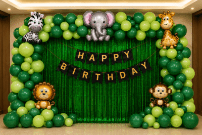 Safari Theme Birthday Decoration Safari theme birthday decoration with green balloon arch, animal foil balloons, green fringe curtain and happy birthday banner.