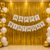 White and Gold Birthday Decoration with Foil Curtain White and gold birthday decoration with metallic balloons, gold foil curtain backdrop and happy birthday banner for elegant party setup.